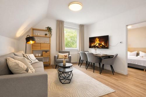 a living room with a couch and a dining room at Emden City Center - Innenstadt in Emden