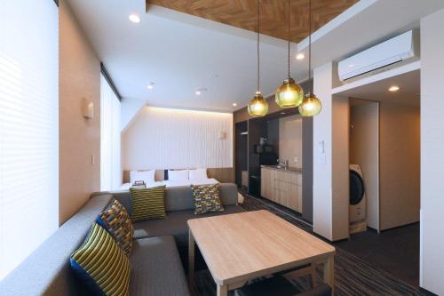 a living room with a couch and a table at stayme THE HOTEL Asakusa Riverside in Tokyo