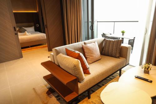 a living room with a couch and a table at Antara Genting Cozy Studio in Genting Highlands
