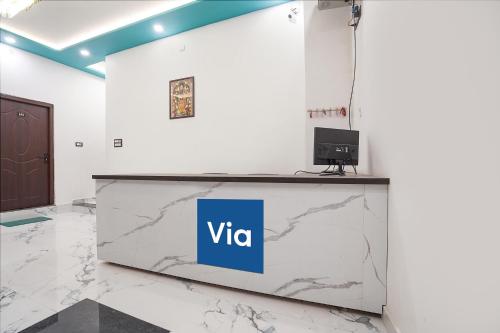 a reception desk with a vita sign on it at Via Awadh Royal in Ayodhya