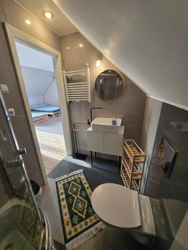 a small bathroom with a sink and a toilet at Cicha Dolina in Wydminy