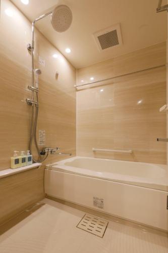 a bathroom with a tub and a shower at stayme THE HOTEL Asakusa Riverside in Tokyo