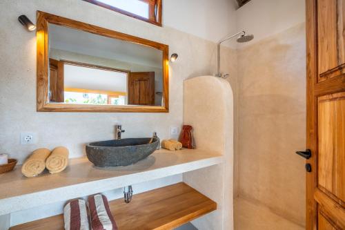 a bathroom with a sink and a mirror at LYS Home in Jimbaran