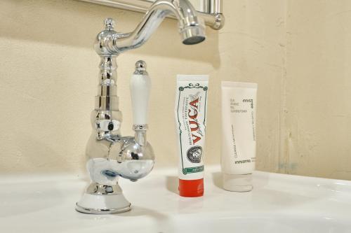 a sink with a faucet and two toothbrushes at The FLOW HOUSE in Suwon