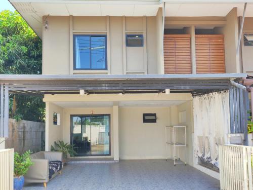 a house with a front door and a porch at Comfortable 3bdr House in Bangtao, Phuket in Ban Pak Lak