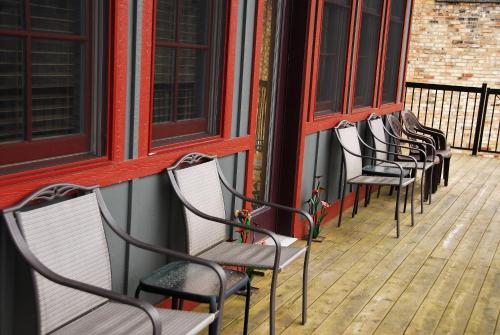 a row of chairs sitting on a porch at Main Street Inn in Lowell