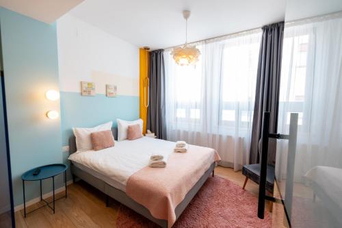a small bedroom with a bed and a window at Stil Old Town Boutique Hotel in Bucharest