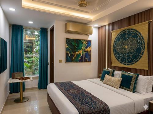 a bedroom with a large bed with blue curtains at Hotel Krone International in Gurgaon