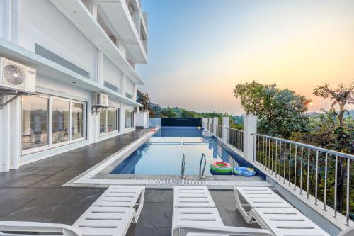 a swimming pool in the backyard of a house at ALAYA STAYS Midpoint UMA Pet-Friendly 7 BHK Villa Pool and Entertainment in Chicalim
