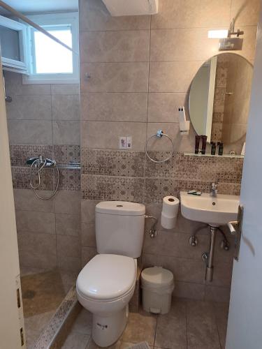 a bathroom with a toilet and a sink at Anastasia Studios & Apartments in Panormos Skopelos