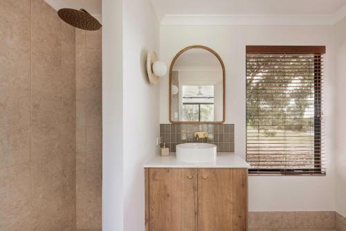 a bathroom with a sink and a mirror at Wilyabrup Waters Retreat in Wilyabrup