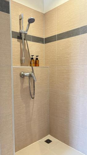 a shower with a shower head in a bathroom at Beachfront Pool Villa in Ko Chang