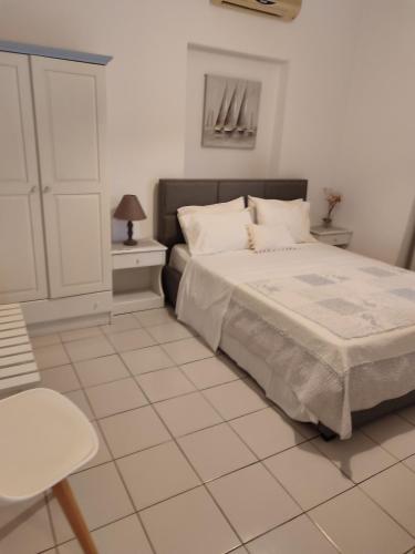 a bedroom with a bed and a tiled floor at Anastasia Studios & Apartments in Panormos Skopelos