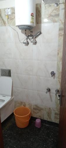 a bathroom with a shower with a sink and a toilet at SK Hotel Raisingh Nager in Rāisinghnagar
