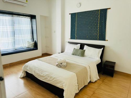 a bedroom with a large bed with a toy truck on it at MARIGOLD VILLA Il 3BHK II AC II POOL II in Lonavala