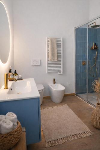 a bathroom with a sink and a toilet and a shower at ClaMar Apart Hotel in Porto Ercole