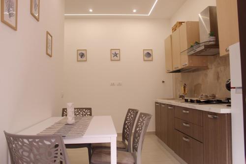 a kitchen with a table and chairs in a kitchen at Casa DieciMare in Torre del Greco