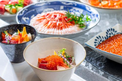 a group of bowls of food on a table at La'gent Stay Hakodate Ekimae in Hakodate