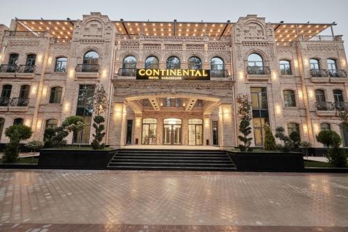 a building with a sign on the front of it at Continental Hotel Samarkand in Samarkand