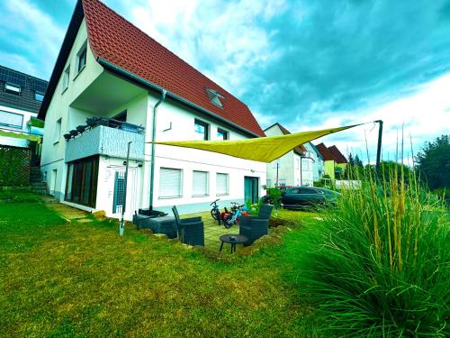 a house with a yellow canopy in front of it at DreamHouse Apartments in Künzelsau