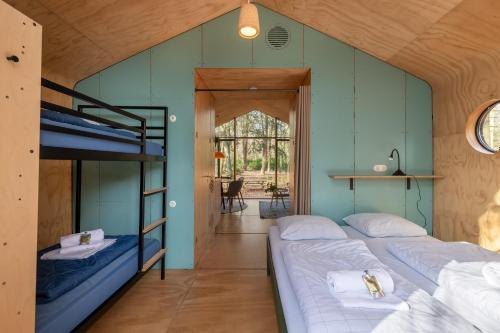 two beds in a room with blue walls at Stayokay Hostel Apeldoorn - Fully renovated March 2026 in Apeldoorn