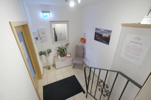 a stairway with a mirror and a sink in a room at Haus Mila in Bienenbüttel
