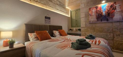 a bedroom with a bed with two stuffed animals on it at The Alley Suites in Gudja