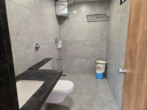 a small bathroom with a toilet and a sink at Gajraj Hotel in Vadodara