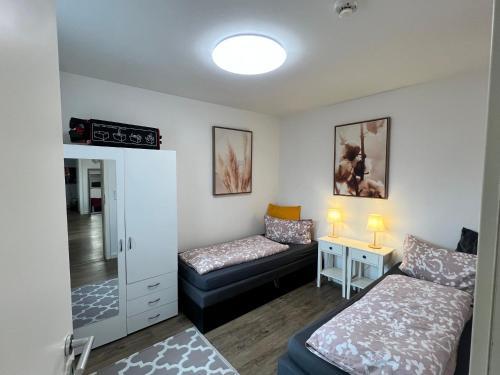 a small room with a bed and a couch at Apartment CentrumMitte Anger in Erfurt