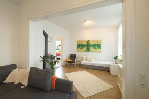 a living room with a couch and a table at Studio Apartment nahe Lüneburg in Bienenbüttel