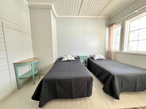 a room with two beds and a window at Vuohensaari, Rantatalo 2 in Salo