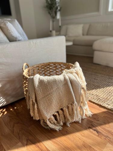 a wicker basket sitting on a floor in a living room at Saltwater at Warilla Beach in Lake Illawarra