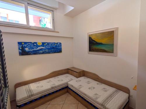a room with two beds in it with a window at Grottammare mon amour Kira in Grottammare
