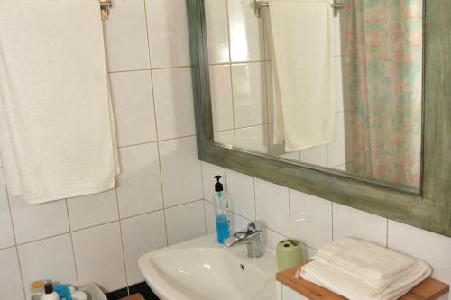a bathroom with a sink and a mirror at Vila Vasi- Μodern maisonette view Meteora in Kastraki