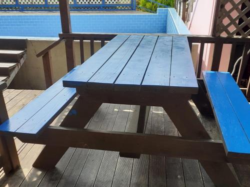 a blue picnic table sitting on a deck at Geoje Milky Way Pension in Geoje