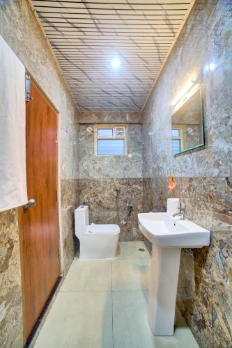 a bathroom with a sink and a toilet at Hotel Airline Inn - Near Kempegowda International Airport in Muthugadahalli