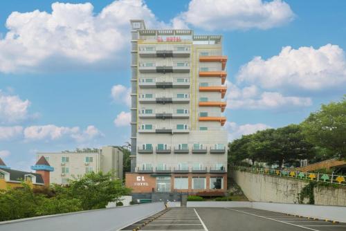 a tall building with a parking lot in front of it at CL Hotel in Boryeong