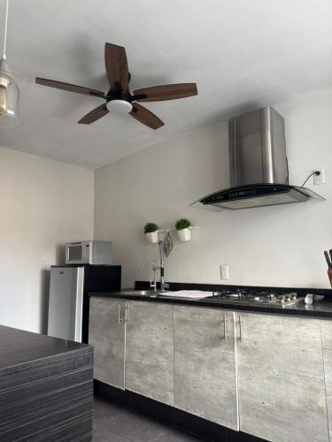 a kitchen with a ceiling fan and a counter top at Casa providencia suites in Guadalajara