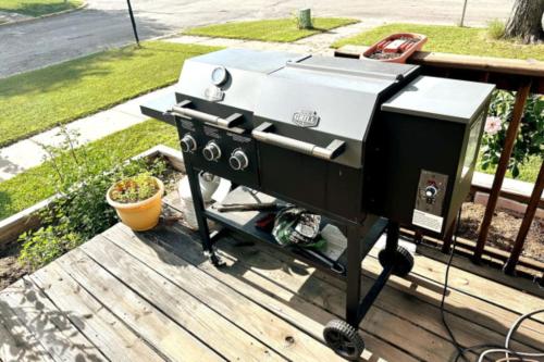 a grill sitting on a deck on a porch at Hot Tub 5 beds in Moorhead