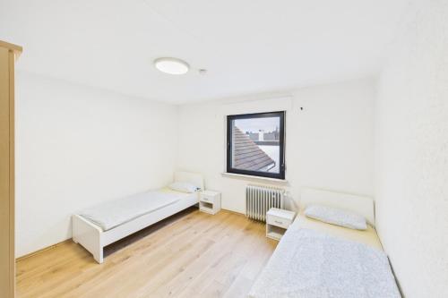 a room with two beds and a window at Ankas Ferienwohnung 2 in Bexbach