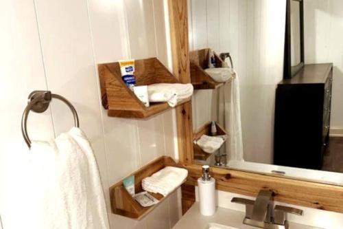 a bathroom with a sink and a mirror and towels at Hot Tub 5 beds in Moorhead