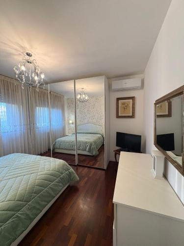 a bedroom with two beds and a mirror at Al Colosseo Quadrato in Rome