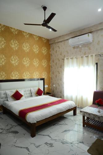 a bedroom with a large bed and a window at Maa Mandakini Resort & Hotel in Chitrakoot