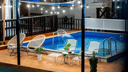 a deck with chairs and a swimming pool at Gyeongju Areum Maru in Gyeongju