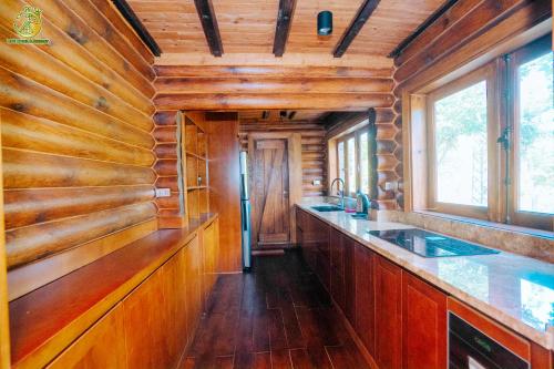 a kitchen with wooden walls and a counter with a sink at Ume Villa & Retreat in Bóng Suối