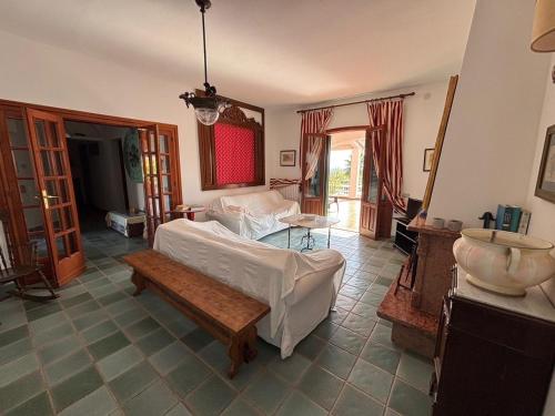 a bedroom with a bed and a table in it at Villa Bianca Plemmirio in Syracuse