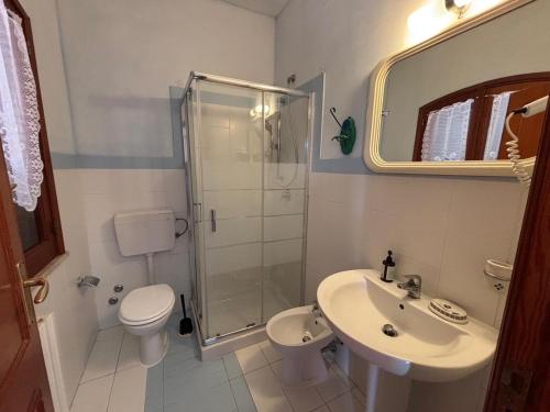a bathroom with a sink and a toilet and a shower at Villa Bianca Plemmirio in Syracuse