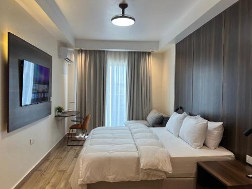 a hotel room with a large bed with white pillows at Mayfair Hotel in Dar es Salaam