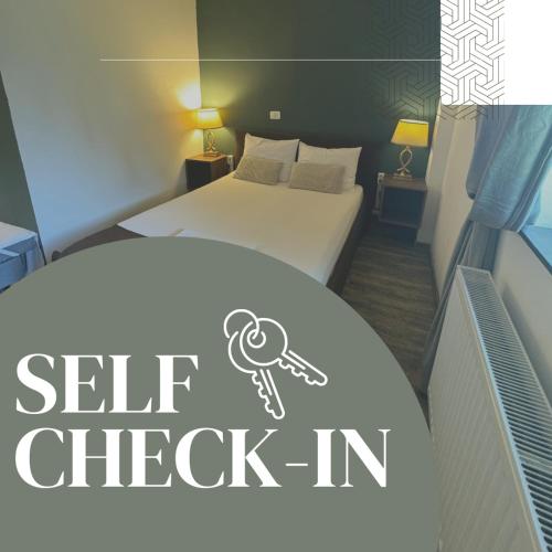a bedroom with a bed with a key sign on it at La Livada in Otopeni