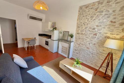 a living room with a couch and a kitchen at Old Antibes 1 Bedroom 4 Persons in Antibes